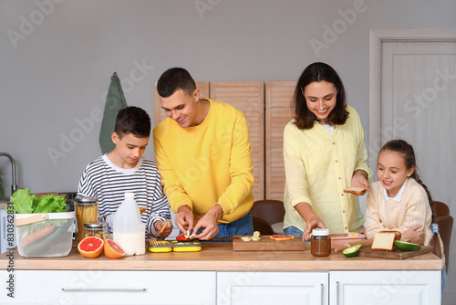Happy family cooking in kit...