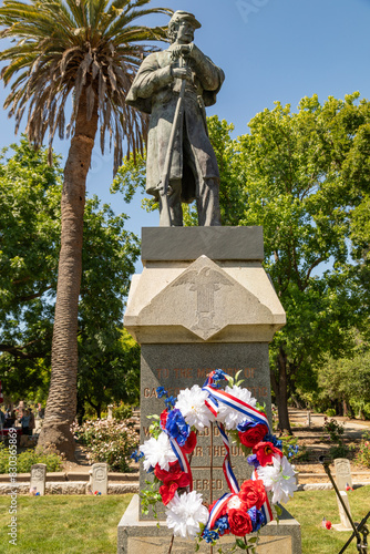 Statue of Civil War Era Soldier at Union Cemetery in Redwood City, California on Memorial Day with Red, White and Blue Wreath photo