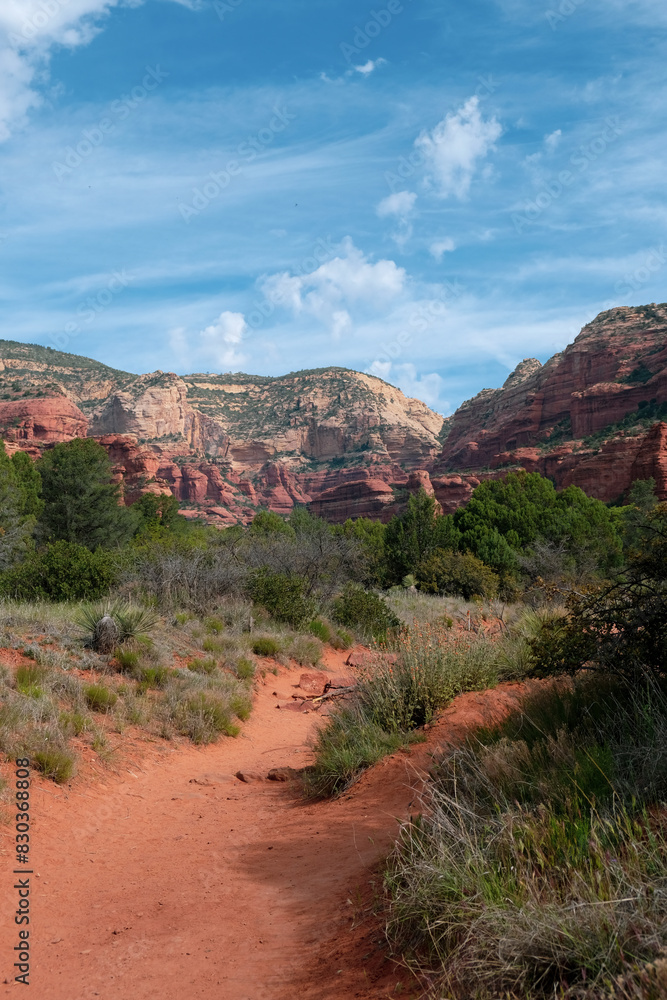 Whispy blue clouds and red rock formations near Bell Rock in Sedona, Arizona