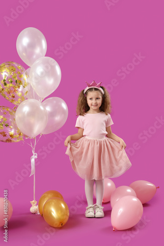 Cute little girl with ballo...