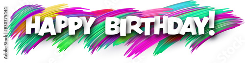 Happy birthday paper word sign with colorful spectrum paint brush strokes over white.