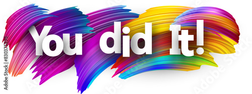 You did it paper word sign with colorful spectrum paint brush strokes over white.