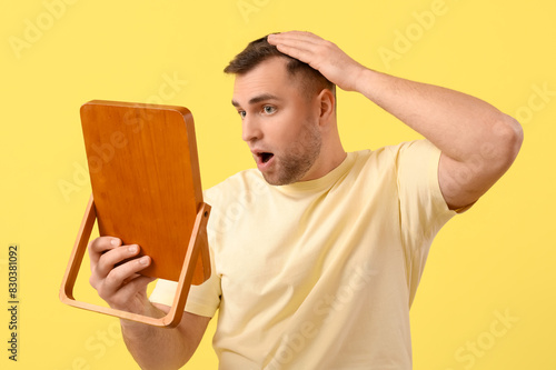 Shocked young man with hair...