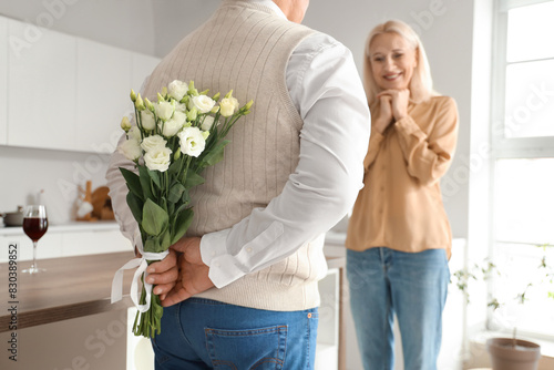 Mature man with flowers for...