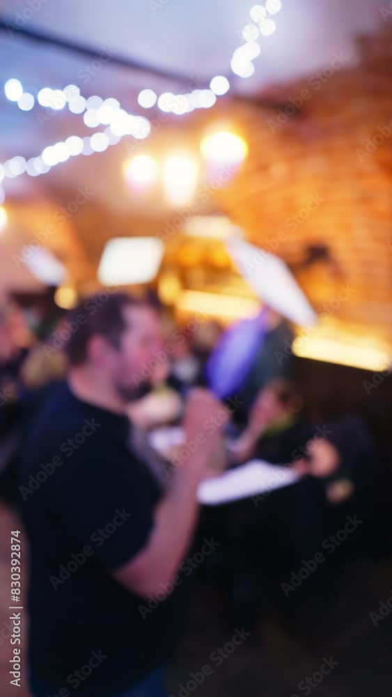 Group Engaged in Pub Quiz Game - Vertical Defocused View Group Engaged in Pub Quiz Game - Vertical Defocused View
