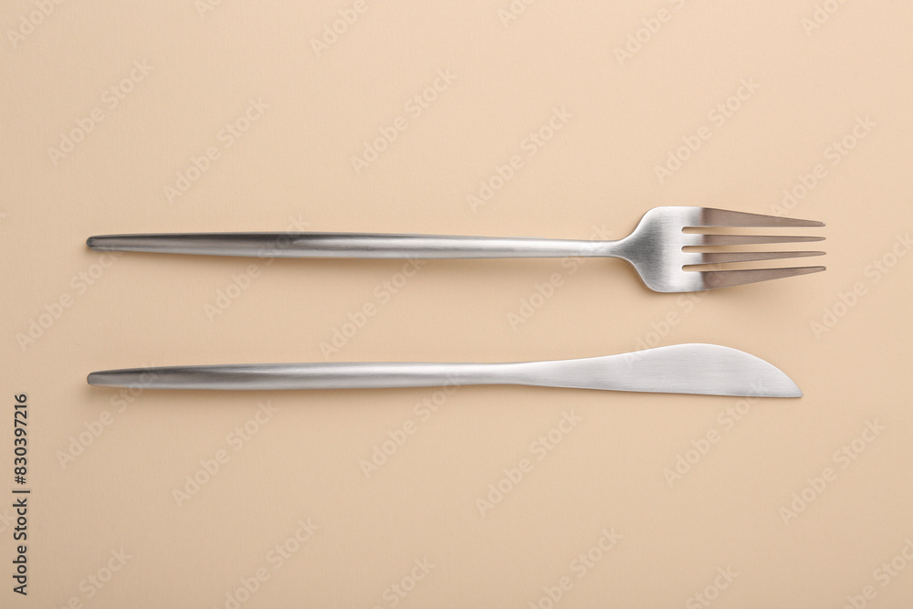 Stylish cutlery on beige table, top view Stylish cutlery on beige table, top view