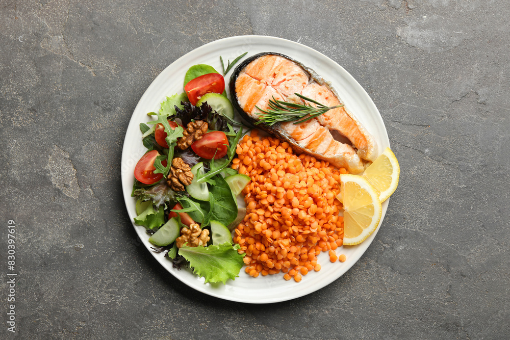 Plate with healthy food high in vegetable fats on grey textured table, top view Plate with healthy food high in vegetable fats on grey textured table, top view