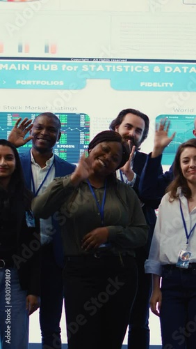 Vertical Video Confident smiling enterprise team uniting their forces to improve workflow and efficiency, achieve organizational goals. Diverse group of analysts work in telecommunications control