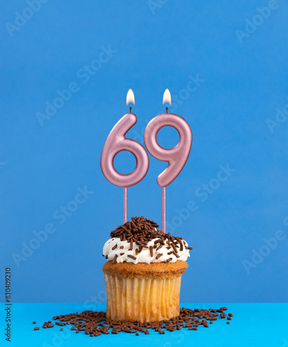 Candle number 69 - Birthday card with cupcake on blue background photo