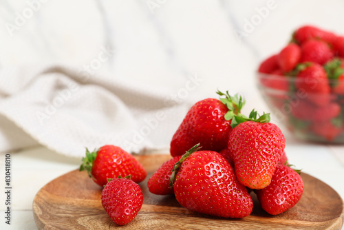 Wooden plate with sweet fresh strawberries on white background  closeup