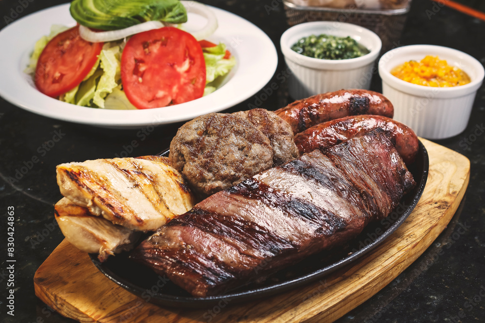 Juicy beef steak, a quarter grilled chicken, two artisan sausages and two mini burgers accompanied by fries and fresh salad. Juicy beef steak, a quarter grilled chicken, two artisan sausages and two mini burgers accompanied by fries and fresh salad.