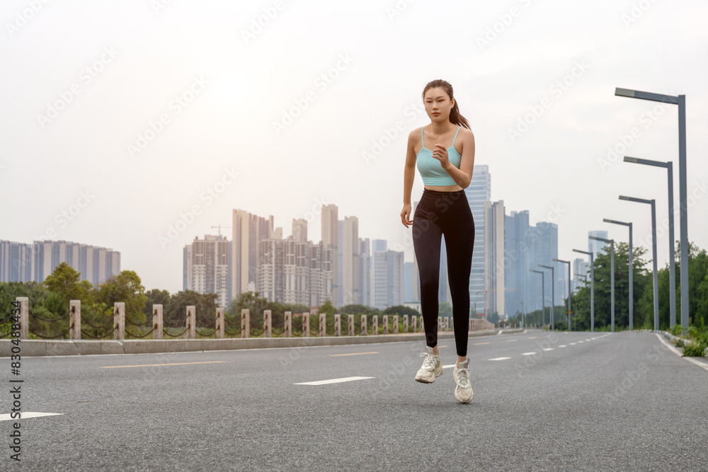 Young women wearing sportswear do warm-up morning runs and fitness exercises Young women wearing sportswear do warm-up morning runs and fitness exercises