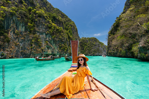 Young woman traveler relaxing and enjoying at Pi leh Lagoon at ko Phi Phi lay island in Krabi, Thailand, Summer vacation and Travel concept photo