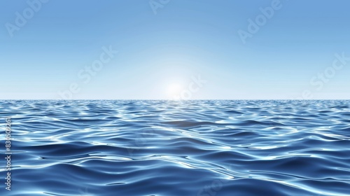  A large body of water beneath a blue sky, with the sun casting golden rays upon its blue horizon