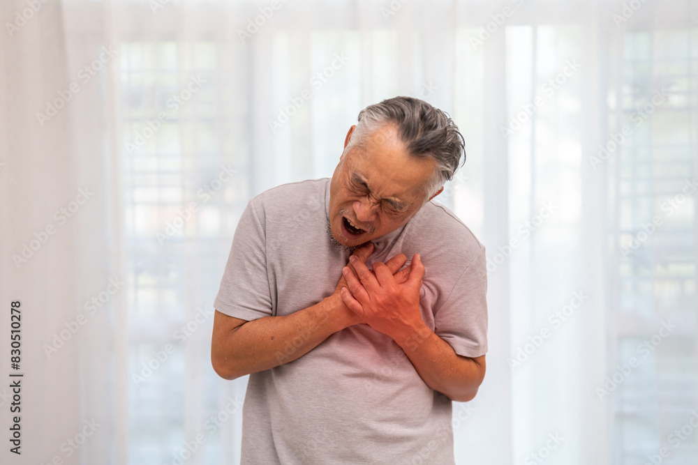 Senior asian adult elderly man with chest pain suffering from heart attack, health and medical, heart health, heart attack, world heart day, cardiovascular disease.insurance and hospital concept Senior asian adult elderly man with chest pain suffering from heart attack, health and medical, heart health, heart attack, world heart day, cardiovascular disease.insurance and hospital concept