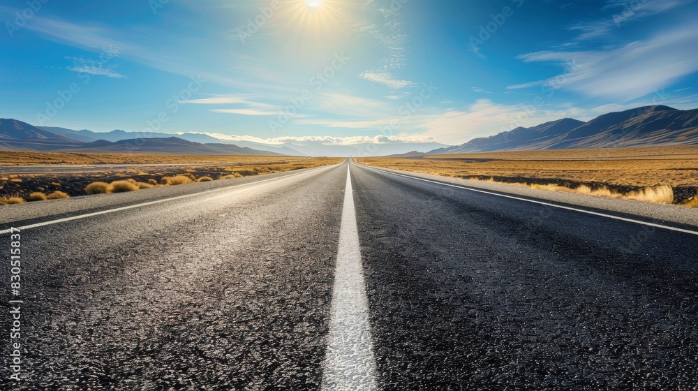 A long, empty road stretches towards the horizon, framed by mountains and a bright blue sky. The road symbolizes journey, opportunity, and the unknown. A long, empty road stretches towards the horizon, framed by mountains and a bright blue sky. The road symbolizes journey, opportunity, and the unknown.