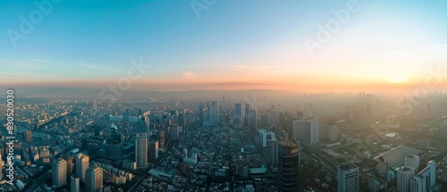 Aerial view of a city skyline at sunrise.