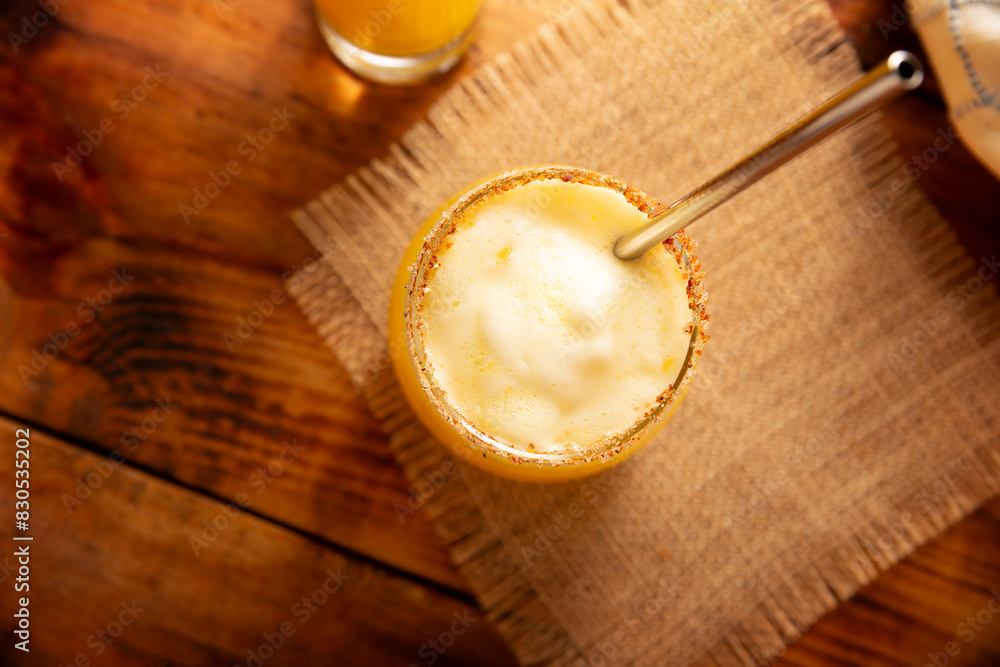 Pineapple cooler drink, served in a glass glass on a wooden table, in Mexico it is called Agua de Piña and is part of the traditional Aguas Frescas. Pineapple cooler drink, served in a glass glass on a wooden table, in Mexico it is called Agua de Piña and is part of the traditional Aguas Frescas.