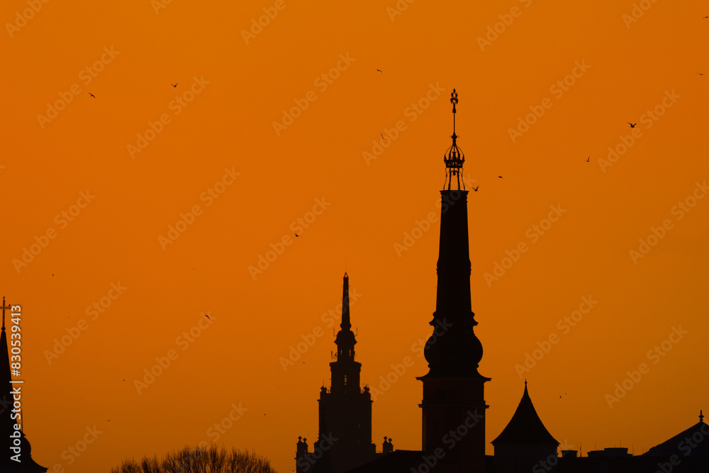 A beautiful Riga cityscape during colorful sunrise. Buildings against colorful sky. Northern Europe morning with warm sky.