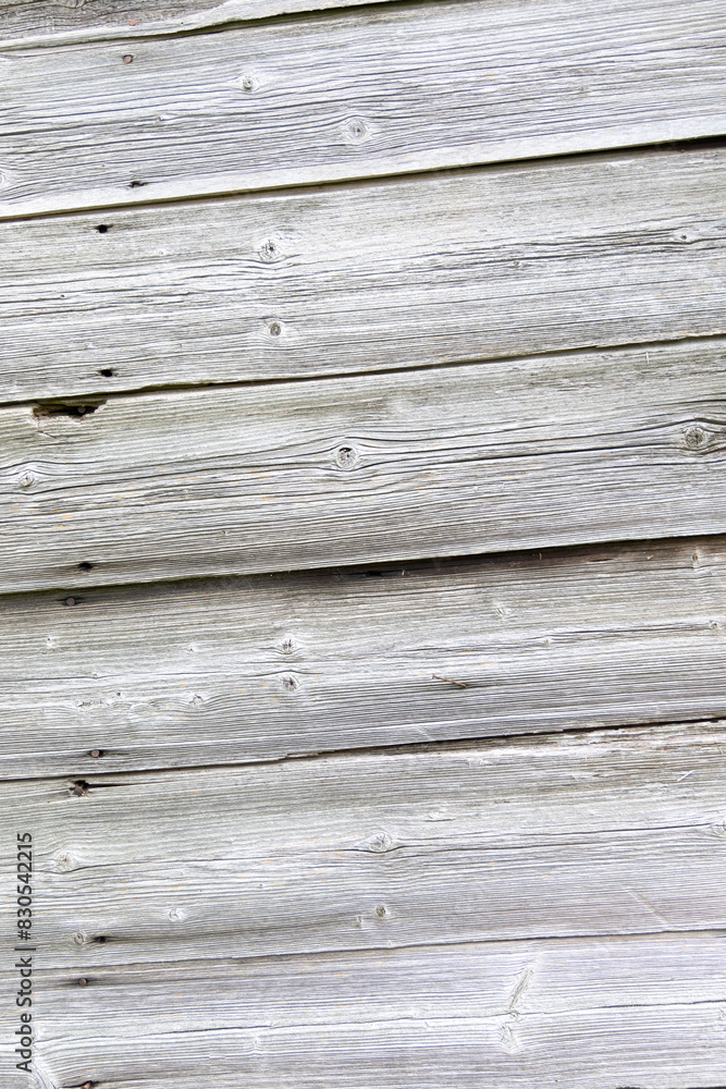 An old wooden wall texture of abandoned building. Old wood planks on a house. Latvia, Europe. An old wooden wall texture of abandoned building. Old wood planks on a house. Latvia, Europe.