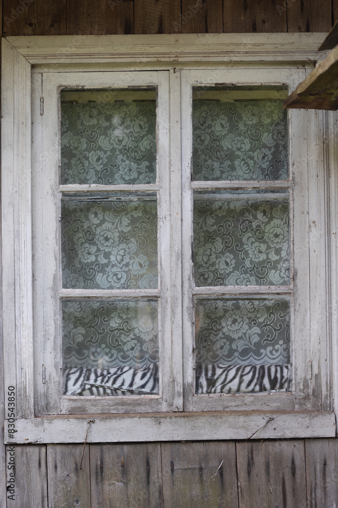 a beautiful wooden window frame of a historic log building. Old house in Latvia, Europe. a beautiful wooden window frame of a historic log building. Old house in Latvia, Europe.