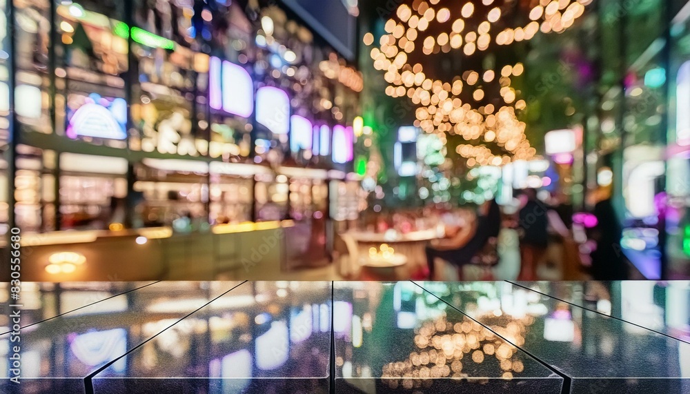 Empty black marble counter top with colorful, blurred nightclub bokeh lights in the background. Empty black marble counter top with colorful, blurred nightclub bokeh lights in the background.