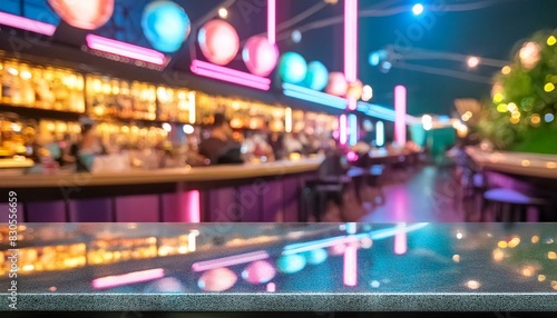 Black marble bar counter in a blurred nightclub setting, ideal for nightlife or hospitality concepts.