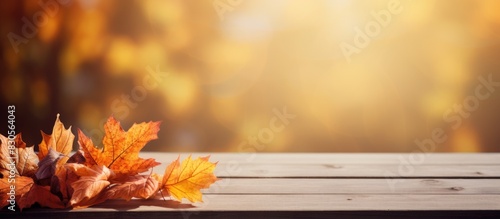 Beautiful autumn leaves on a wooden table create a captivating background with plenty of copy space for an image