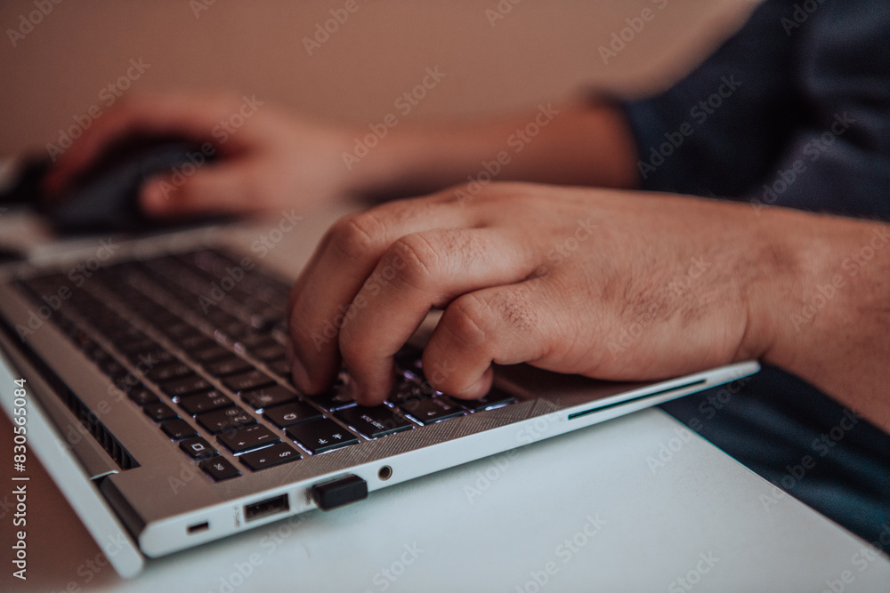 Close-up photo of a programmer typing on a laptop Close-up photo of a programmer typing on a laptop