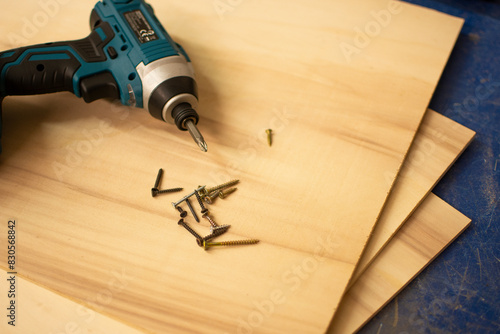 SCREWDRIVER AND WOODEN BOARD