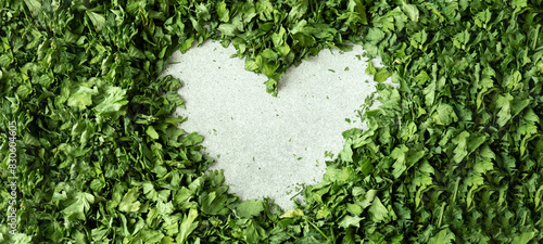 Background of green dry parsley in heart shape. Vegetarian bio organic salad lover herb healthy eating. Home garden immunity-boosting herbs. Seasonal harvest cottagecore