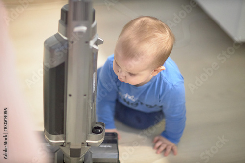 Baby Playing With Vacuum Cleaner in Room