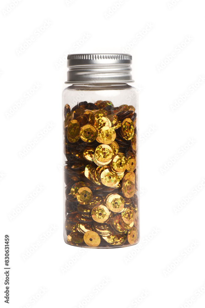 Golden sequins in the transparent jar bottle isolated on the white background. Front view. Golden sequins in the transparent jar bottle isolated on the white background. Front view.