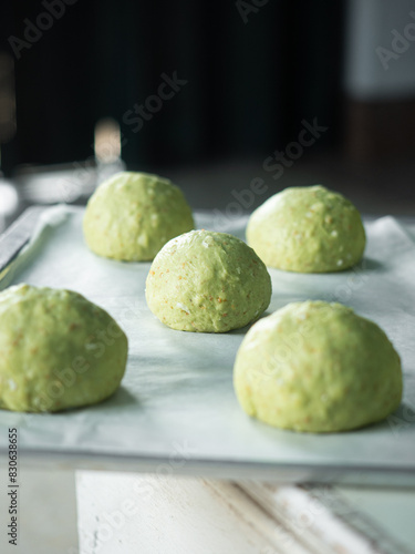green bread roll dough on baking tray