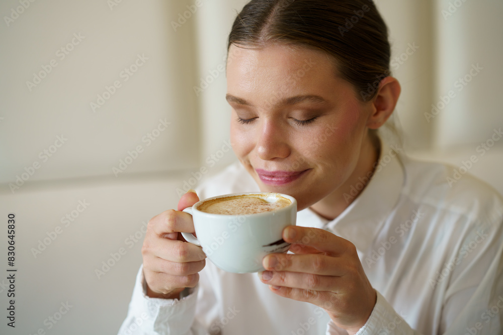 Beauty woman smelling a delicious coffee in a cafeteria Beauty woman smelling a delicious coffee in a cafeteria