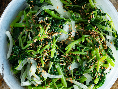 top view spinach with white sesame and onion