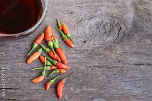 Fish sauce with red chili on wood table photo