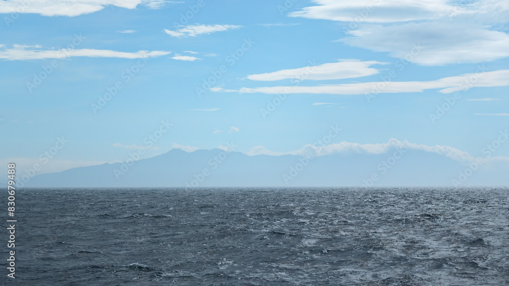 Beautiful seascape from water to mountain on horizon. Clip. View from floating boat to sea horizon and mountain coast. Sea trip by boat in sea