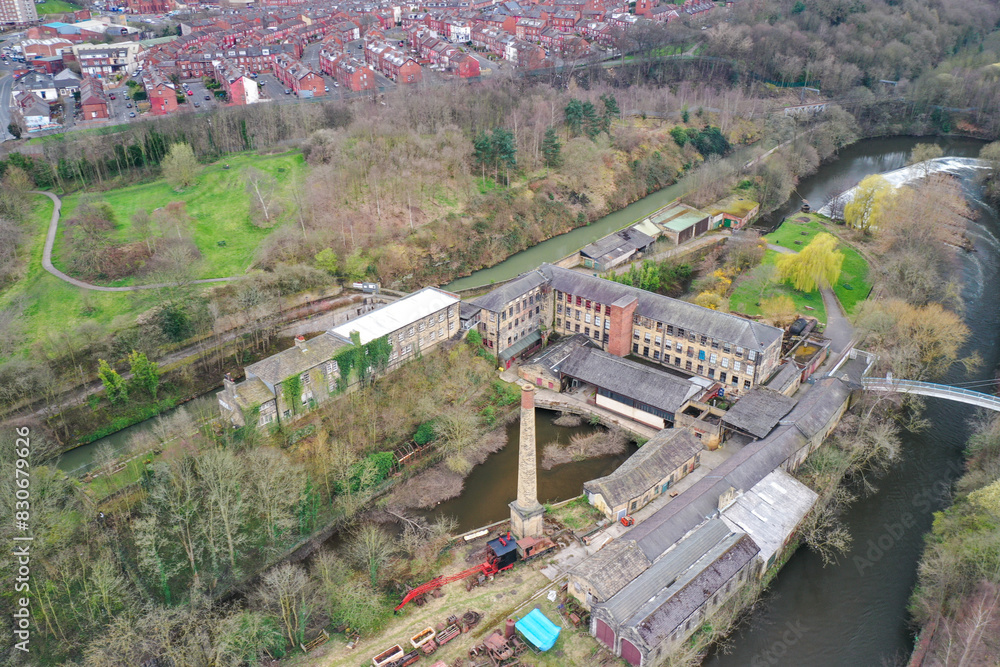 Aerial photo of the village of Armley in the city of Leeds in the UK showing the historic Leeds Industrial Museum at Armley Mills at the side of the canal in the winter time