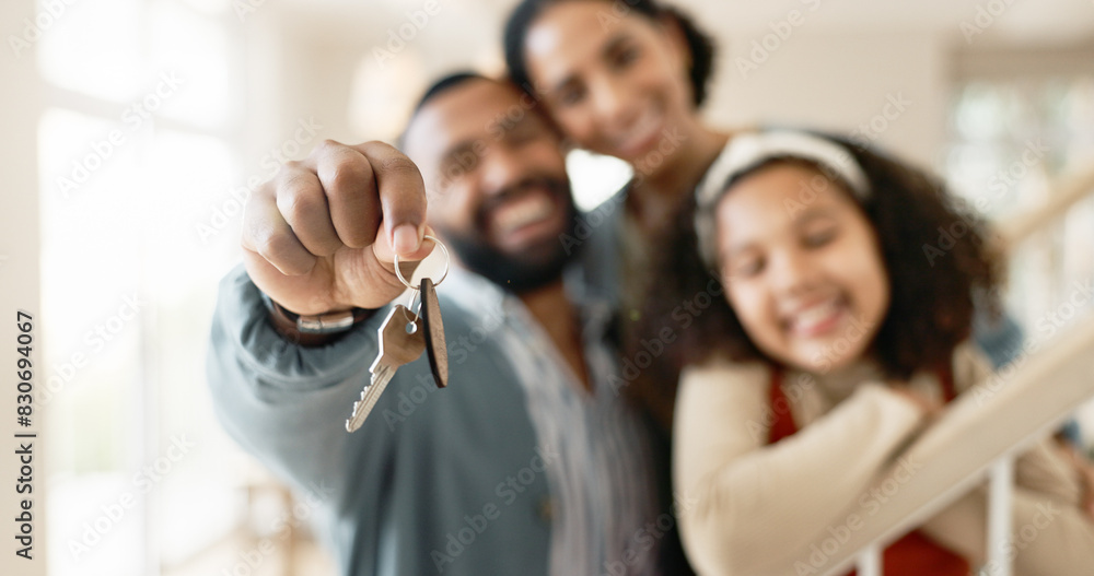 © peopleimages.com - Parents, girl and hands with keys in new home or apartment, relocation and property purchase for investment or achievement. Mom, dad and child together with mortgage loan, milestone and celebration.