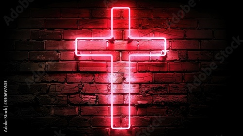 A red cross is lit up against a brick wall