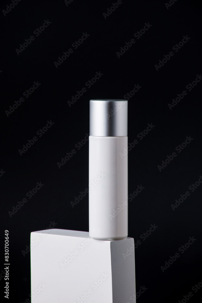 Plastic white tube for cream or lotion. Skin care or sunscreen cosmetic with stylish props on black background. Plastic white tube for cream or lotion. Skin care or sunscreen cosmetic with stylish props on black background.