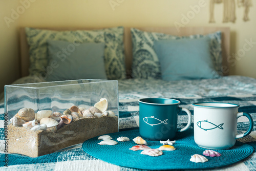 Cups of tea in a nautical style on the bed. Good morning.