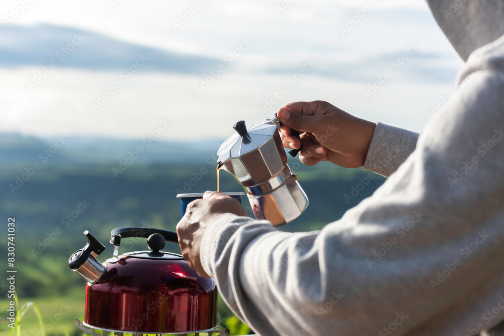 Naklejka premium Making drip coffee with a beautiful mountain and nature view in background