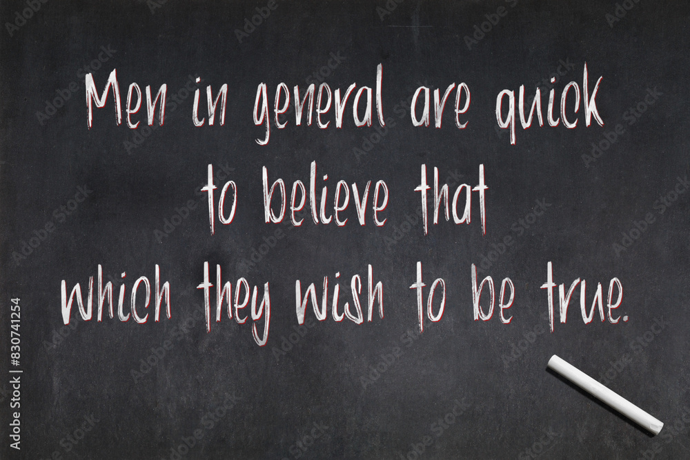 Fototapeta premium Quote from Julius Caesar about confirmation bias written on a blackboard