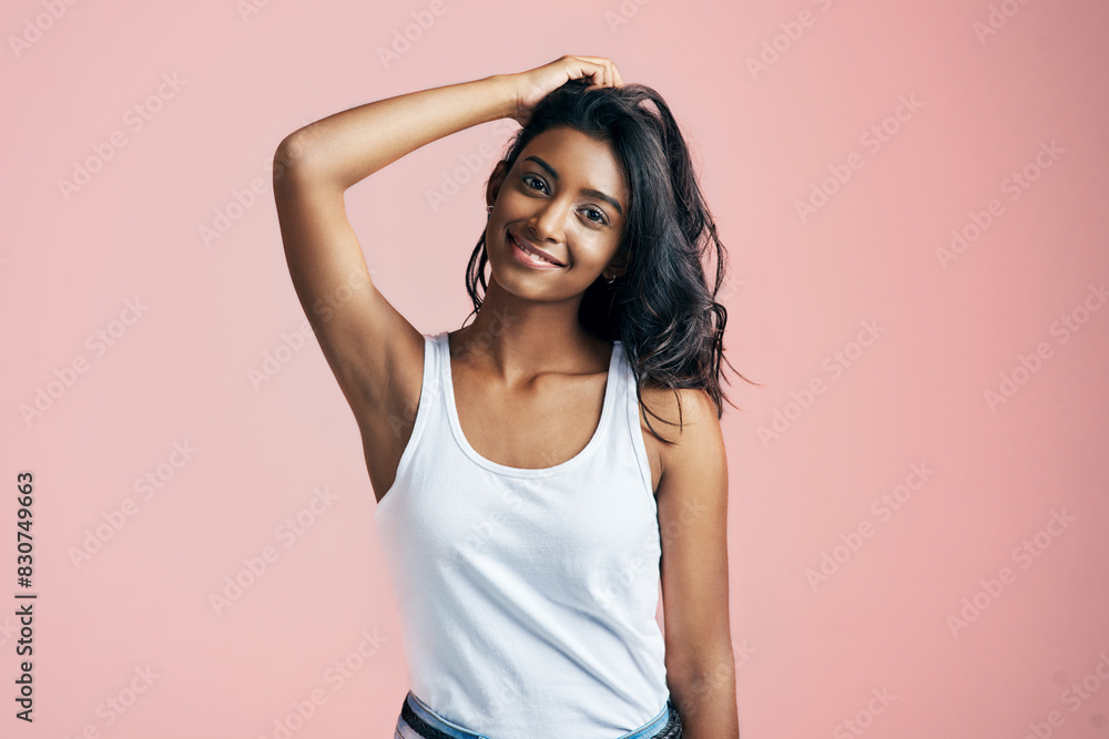 Portrait, smile and Indian girl in studio for hair care, skincare and casual fashion on pink background. Smooth skin, happy and female person with salon treatment for wavy style, keratin and volume Portrait, smile and Indian girl in studio for hair care, skincare and casual fashion on pink background. Smooth skin, happy and female person with salon treatment for wavy style, keratin and volume