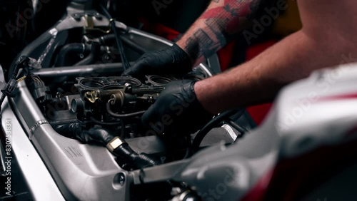 close up In a motorcycle repair shop master deals with the wiring in the motor system