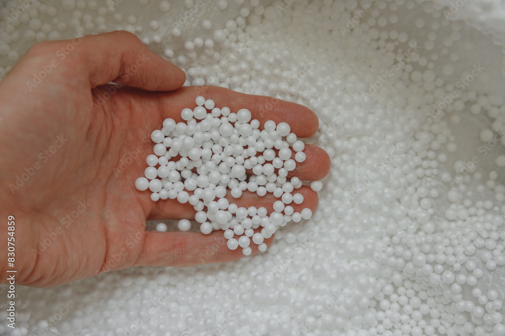 Polystyrene balls in hand. Packaging of fragile goods, filling for chair bags and pillows Polystyrene balls in hand. Packaging of fragile goods, filling for chair bags and pillows