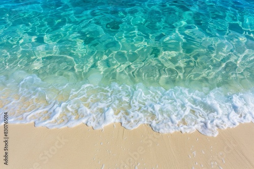 Close-up of sand beach with sparkling ocean water under sunlight - vacation, travel, celebration