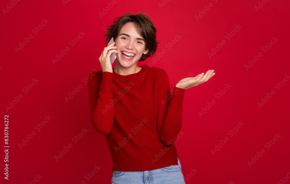 Close up image of positive smiling stylish student female lady speaks communicate cellphone or smartphone isolated on red vivid background Close up image of positive smiling stylish student female lady speaks communicate cellphone or smartphone isolated on red vivid background